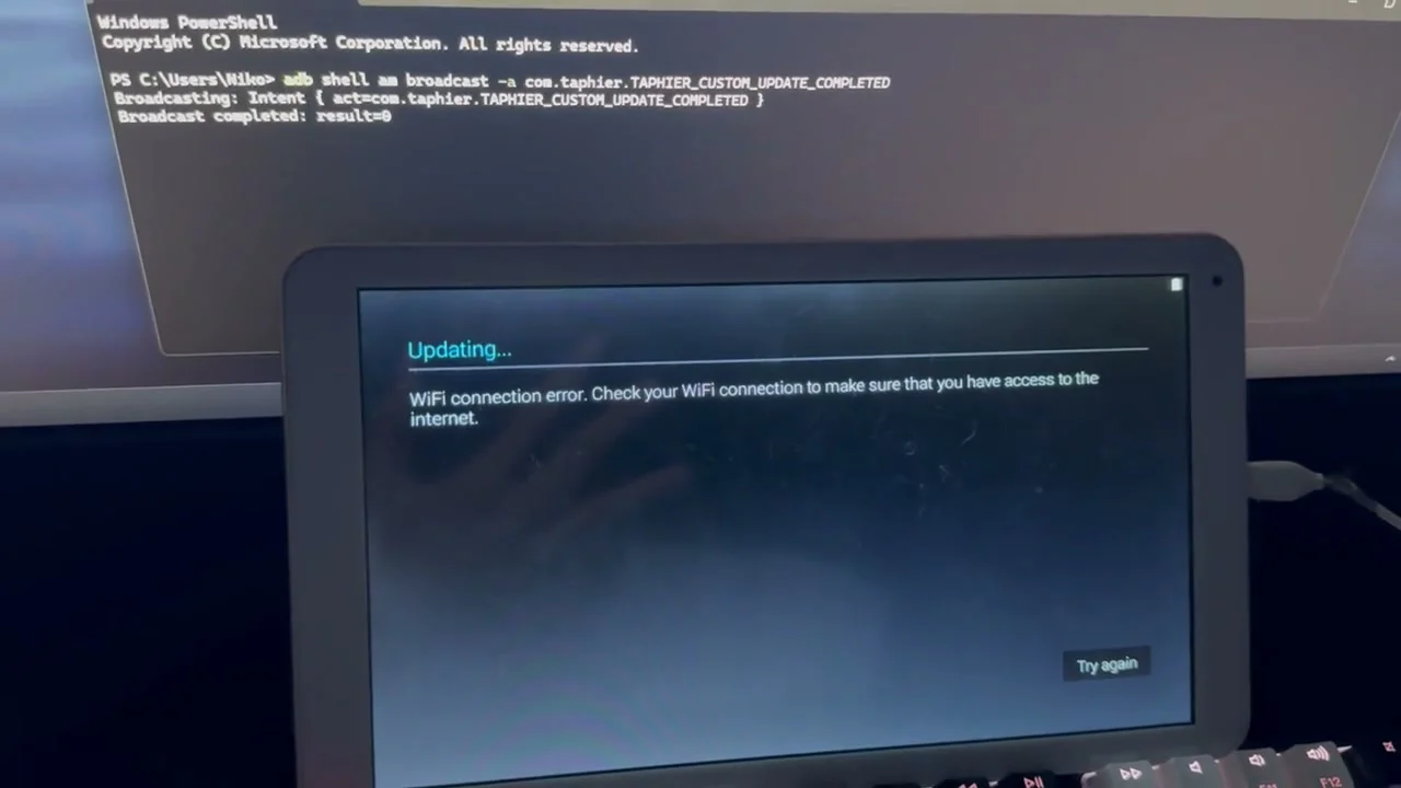 An adb command broadcasting the custom-update completion intent while the TrekStor tablet leaves its broken update screen